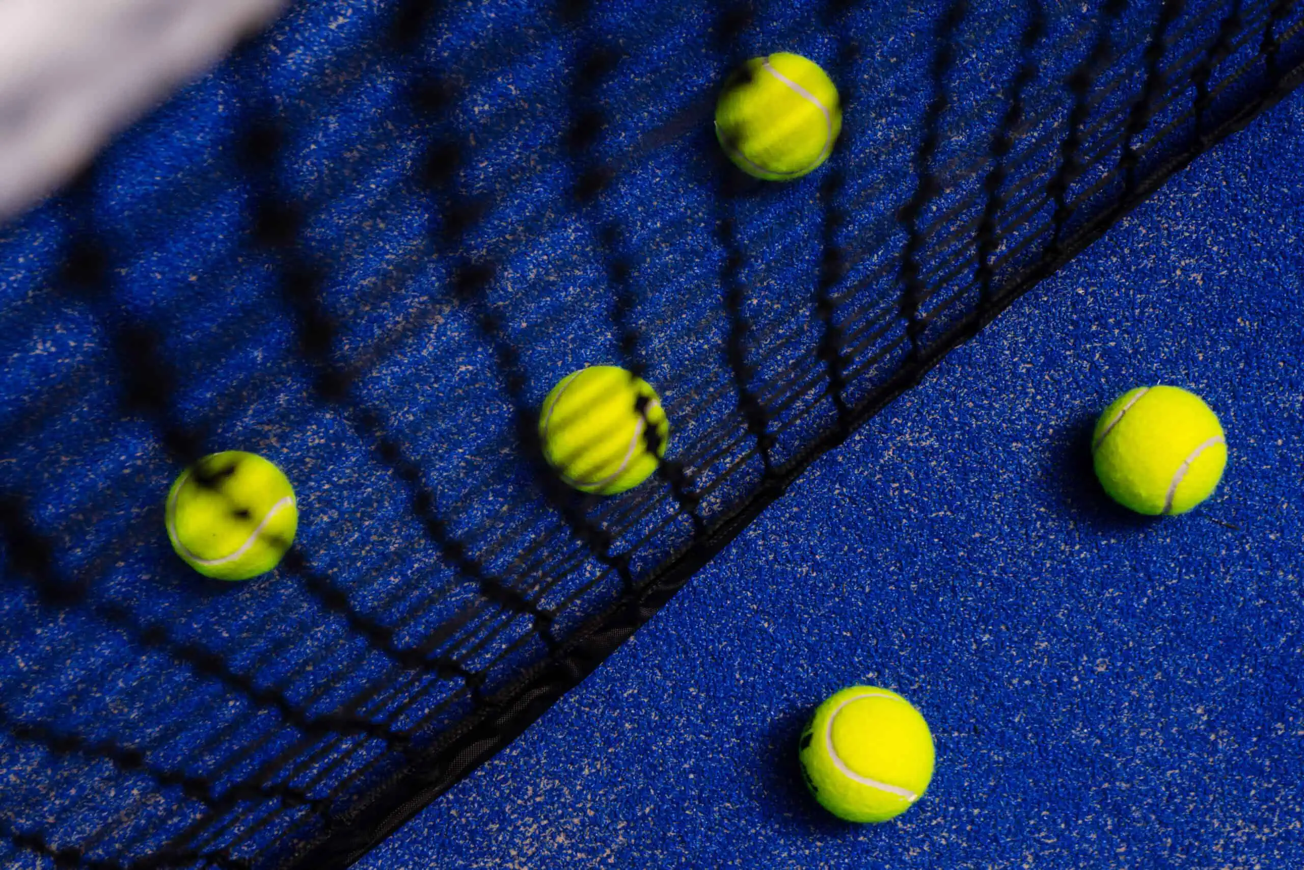 tennis balls on a blue surface